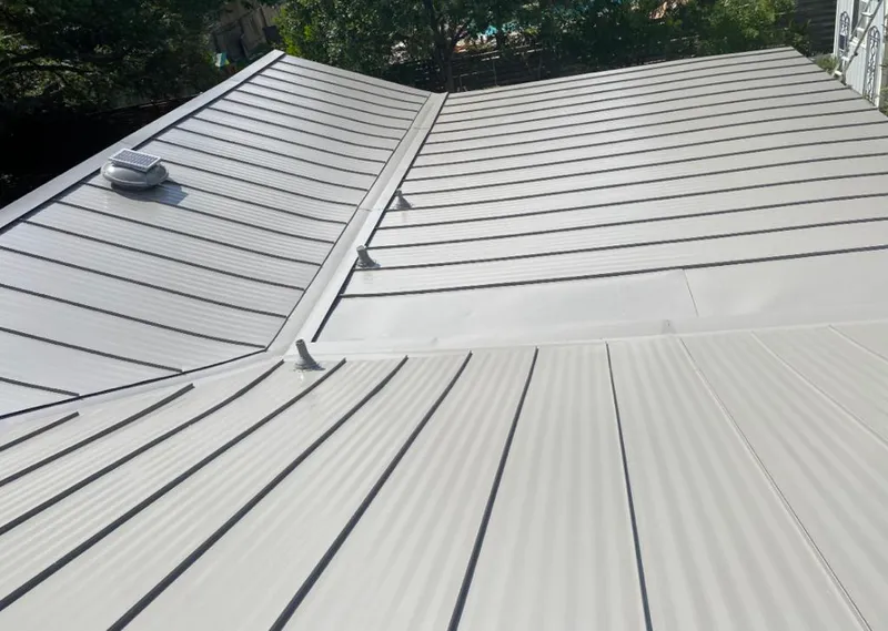 Solar attic fan installed on a metal roof for Roof Ventilation in Overlea